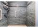 Walk-in shower featuring attractive blue tiling and a convenient grab bar at 7877 E Mississippi Ave # 607, Denver, CO 80247