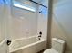 Bathroom showcasing a shower and white tile at 9477 Market Ln, Parker, CO 80134