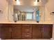 Bathroom features double vanity, quartz countertops, and well-lit mirror; with a view to an elegant walk-in shower at 9477 Market Ln, Parker, CO 80134