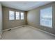 Clean, carpeted bedroom featuring three windows for ample natural light at 9477 Market Ln, Parker, CO 80134
