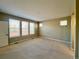 Bright bedroom with large windows offering ample natural light, complemented by neutral carpeting and walls at 9477 Market Ln, Parker, CO 80134