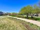 Picturesque community park with a paved walking path and lush green space at 9477 Market Ln, Parker, CO 80134