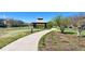 Picturesque community park with a paved walking path and lush green space at 9477 Market Ln, Parker, CO 80134