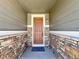 Charming covered front door with brick accents, creating an inviting entrance to the home at 9477 Market Ln, Parker, CO 80134