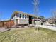 Inviting single-Gathering home with well-manicured lawn, rock features and an attached two-car garage at 9477 Market Ln, Parker, CO 80134