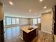 Modern kitchen boasts an island with sink and stainless steel appliances, seamlessly flowing into a spacious living area at 9477 Market Ln, Parker, CO 80134