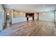 Expansive living room featuring wood floors, recessed lighting, and a seamless transition to the kitchen area at 9477 Market Ln, Parker, CO 80134