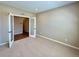 Bright home office with carpet, neutral paint, and glass paneled doors at 9477 Market Ln, Parker, CO 80134