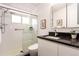 Modern bathroom with a walk-in shower featuring glass doors and dark counter above the vanity at 1392 S Edison Way, Denver, CO 80222