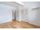 Bright bedroom with hardwood floors, closet, and white trim at 1392 S Edison Way, Denver, CO 80222