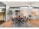 Bright dining area features a round table, modern chairs, and ample natural light from large windows at 1392 S Edison Way, Denver, CO 80222
