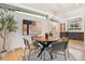 Stylish dining space with a round wood table, contemporary chairs, and modern artwork at 1392 S Edison Way, Denver, CO 80222