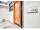 Close-up of the modern wood front door with a sleek handle and updated hardware at 1392 S Edison Way, Denver, CO 80222