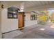 Welcoming front entry featuring a modern wood door and stone landscaping at 1392 S Edison Way, Denver, CO 80222