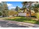 A lovely home with a well-kept lawn and mature trees at 1392 S Edison Way, Denver, CO 80222