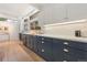 Stylish kitchen featuring dark-tone cabinetry, white countertops, and natural lighting at 1392 S Edison Way, Denver, CO 80222