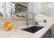 Kitchen features a modern sink, white countertops, and stainless steel faucet at 1392 S Edison Way, Denver, CO 80222