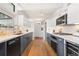 Well-lit kitchen featuring modern appliances, white countertops, and stylish gray and white cabinetry at 1392 S Edison Way, Denver, CO 80222