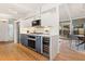 Charming kitchen boasts stainless steel appliances, white countertops, and sleek two-tone cabinetry at 1392 S Edison Way, Denver, CO 80222