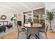 Open-concept living room featuring a dining area and access to the backyard at 1392 S Edison Way, Denver, CO 80222