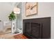 Cozy living room with a black fireplace, neutral chair, and accent lighting near the sliding glass door at 1392 S Edison Way, Denver, CO 80222