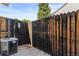 Backyard featuring a wood fence and an air conditioning unit at 14465 E Hawaii Cir # A, Aurora, CO 80012