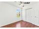 Bedroom featuring wood floors, closet, and a window with an exterior view at 14465 E Hawaii Cir # A, Aurora, CO 80012