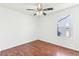 Bedroom featuring wood floors, ceiling fan, and a window with an exterior view at 14465 E Hawaii Cir # A, Aurora, CO 80012