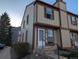 Inviting two-story townhouse with neutral siding, complemented by brown trim and a well-maintained front yard at 14465 E Hawaii Cir # A, Aurora, CO 80012