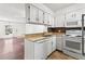 Well-lit kitchen with stainless steel appliances, tile floors and stylish countertops at 14465 E Hawaii Cir # A, Aurora, CO 80012