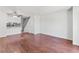 Spacious living room with hardwood floors, ceiling fan and easy access to the staircase at 14465 E Hawaii Cir # A, Aurora, CO 80012