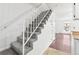 Carpeted staircase with white railing and walls, connecting the home's levels at 14465 E Hawaii Cir # A, Aurora, CO 80012