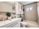 Modern bathroom with a sleek vanity, a stylish mirror, and a shower-tub combo, perfect for a refreshing experience at 5184 E Asbury Ave, Denver, CO 80222