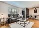 Inviting living room with hardwood floors, a leather sofa, and a stylish glass coffee table, perfect for relaxation at 5184 E Asbury Ave, Denver, CO 80222