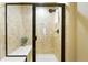 Modern bathroom featuring a tiled shower with a glass door and a convenient built-in bench at 1100 Rockhurst Dr # A, Highlands Ranch, CO 80129