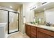 Modern bathroom with a double vanity, granite countertops, and tiled shower at 1100 Rockhurst Dr # A, Highlands Ranch, CO 80129