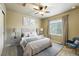 Comfortable bedroom with a ceiling fan, window, and two bedside tables with lamps at 1100 Rockhurst Dr # A, Highlands Ranch, CO 80129