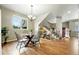 Open dining room with hardwood floors, modern lighting, and a view of the staircase at 1100 Rockhurst Dr # A, Highlands Ranch, CO 80129
