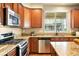 Well-equipped kitchen featuring granite countertops and stainless steel appliances at 1100 Rockhurst Dr # A, Highlands Ranch, CO 80129