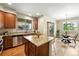 Bright kitchen with a dining area, granite countertops, and stainless steel appliances at 1100 Rockhurst Dr # A, Highlands Ranch, CO 80129