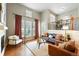 Bright living room with tall ceilings, hardwood floors, and ample natural light at 1100 Rockhurst Dr # A, Highlands Ranch, CO 80129