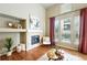 Bright living room with a tiled fireplace, hardwood floors, and a cozy atmosphere at 1100 Rockhurst Dr # A, Highlands Ranch, CO 80129