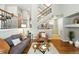 Inviting living room featuring a fireplace, hardwood floors, and open staircase at 1100 Rockhurst Dr # A, Highlands Ranch, CO 80129