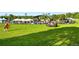 Large open grassy area in the park with people and vendor tents for community gatherings and events at 1100 Rockhurst Dr # A, Highlands Ranch, CO 80129