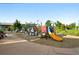 Colorful playground equipment and open space in park offers recreational opportunities at 1100 Rockhurst Dr # A, Highlands Ranch, CO 80129