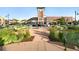 Outdoor seating area in town center with lush landscaping, benches and views of the clock tower at 1100 Rockhurst Dr # A, Highlands Ranch, CO 80129