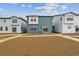 Backyard view of townhomes with a mix of blue and white exteriors at 19058 E 94Th Pl, Commerce City, CO 80022