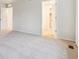 Spacious bedroom featuring carpet and doors to a closet and hallway at 19058 E 94Th Pl, Commerce City, CO 80022