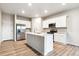 Modern kitchen with stainless steel appliances, white cabinetry, and a center island with a sink at 19058 E 94Th Pl, Commerce City, CO 80022
