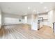 Spacious living and kitchen area featuring stainless appliances, hardwood floors, and ample windows at 19058 E 94Th Pl, Commerce City, CO 80022